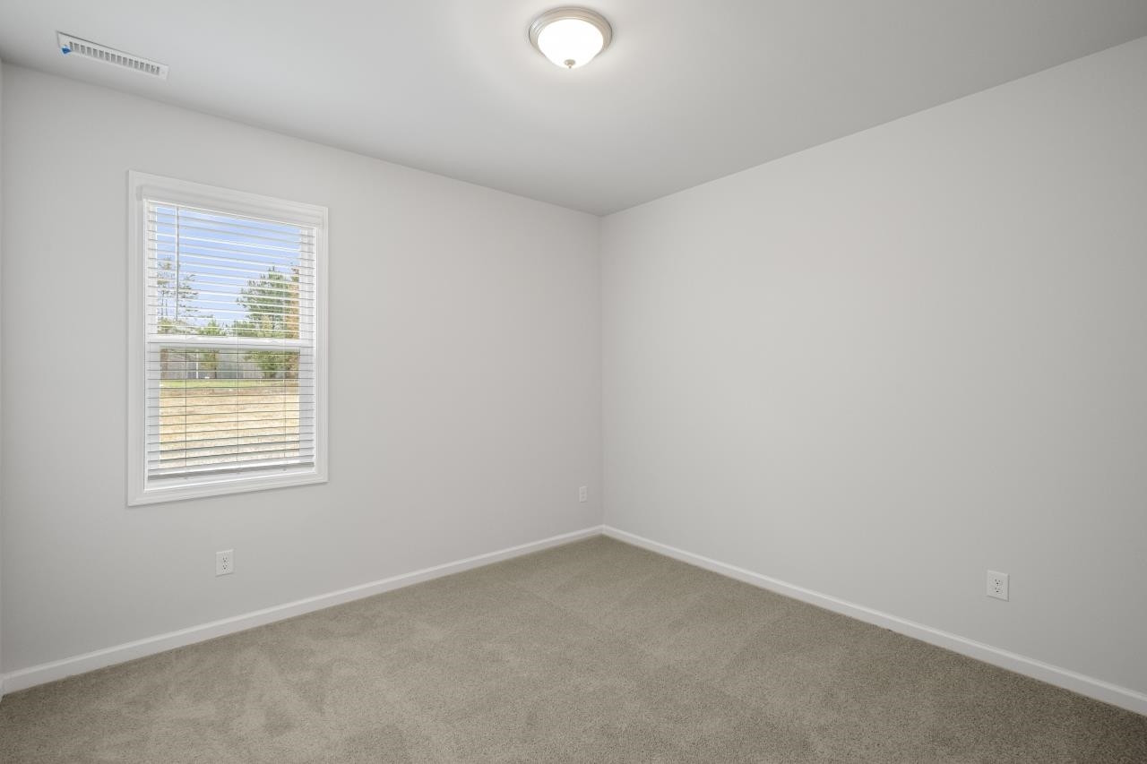 195 Madden Rose Loop Garner, NC 27529 - Photo 28 of 37 an empty room with a window