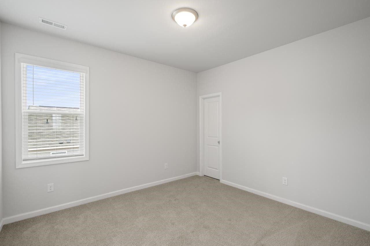 195 Madden Rose Loop Garner, NC 27529 - Photo 29 of 37 an empty room with a window