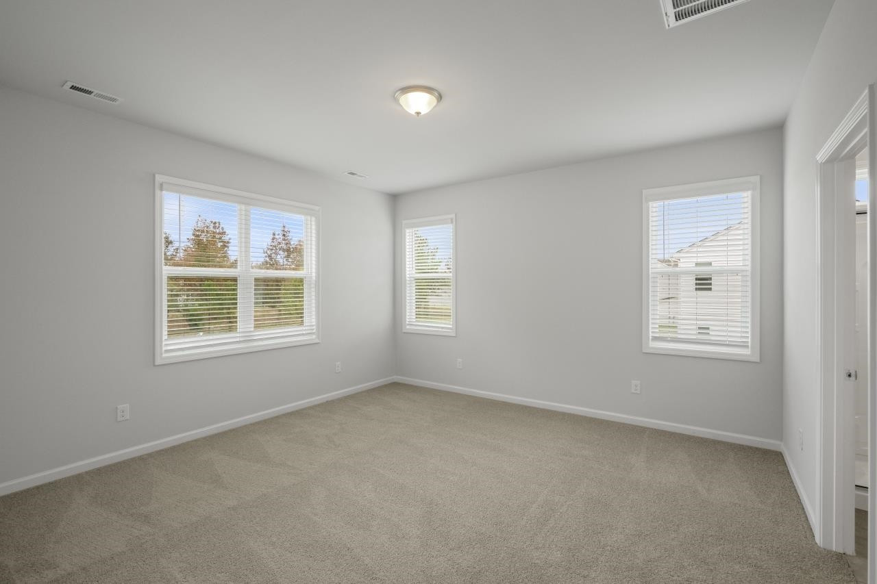 195 Madden Rose Loop Garner, NC 27529 - Photo 32 of 37 an empty room with windows