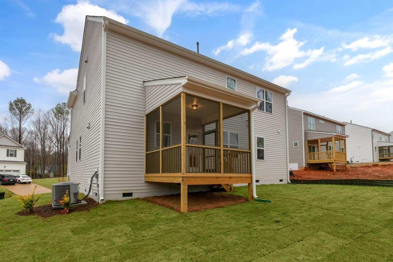195 Madden Rose Loop Garner, NC 27529 - Photo 7 of 37 a backyard of a house with lawn chairs and a fire pit