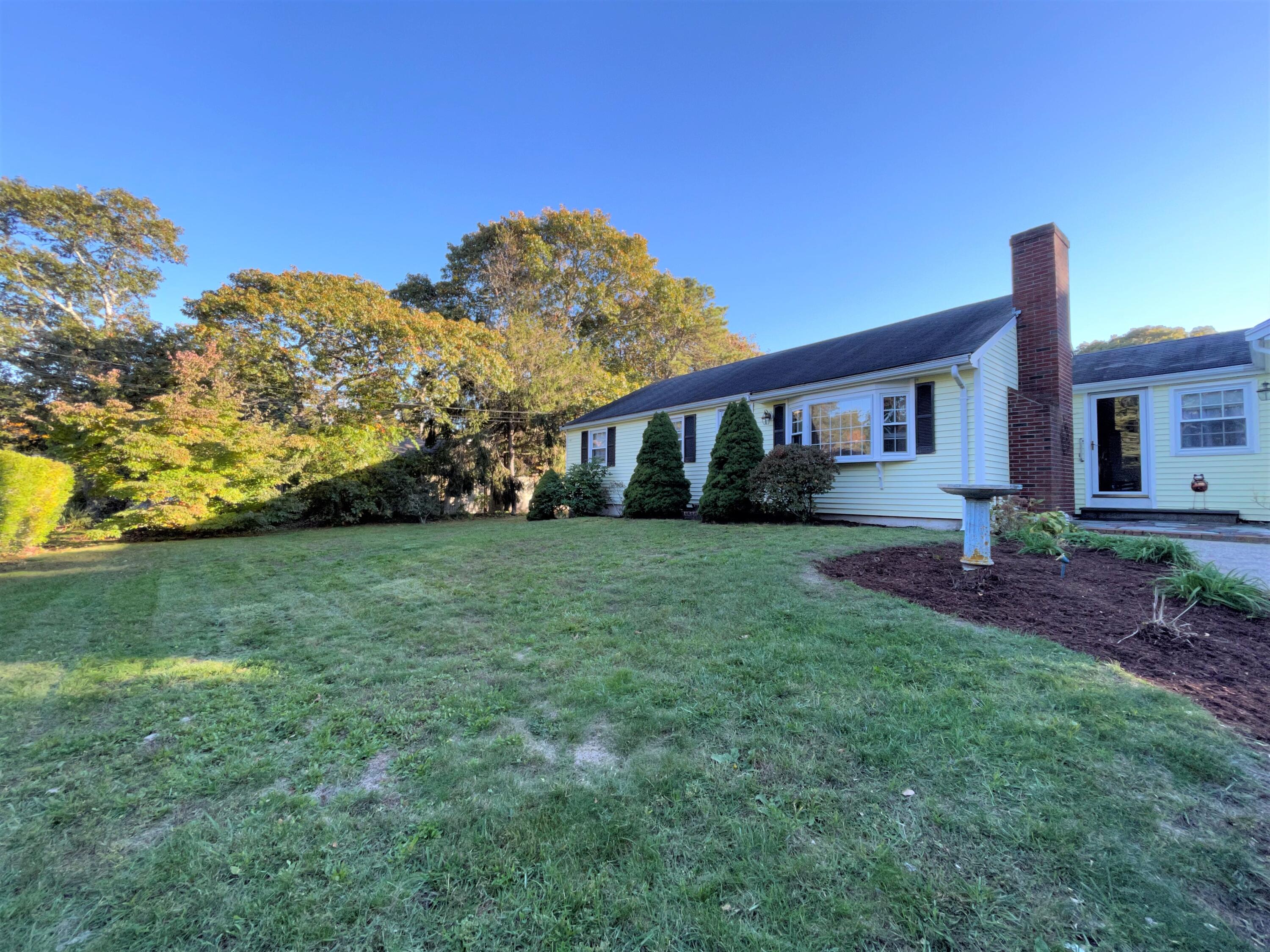 1 Baddeck Street Harwich, MA 02645 - Photo 1 of 24 a front view of a house with garden