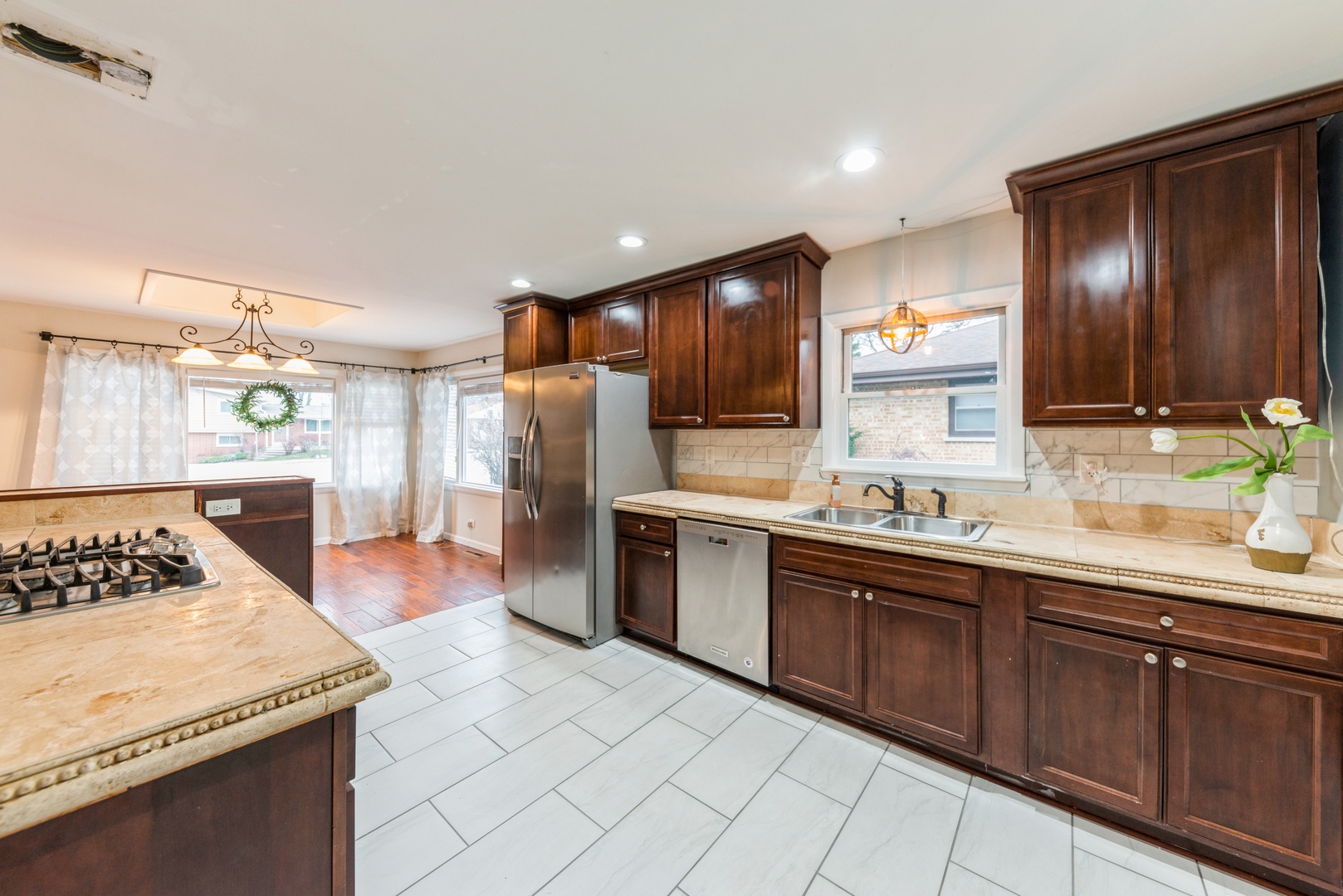 219 North Butterfield Road Libertyville, IL 60048 - Photo 4 of 14 a kitchen with stainless steel appliances granite countertop a sink stove refrigerator and cabinets