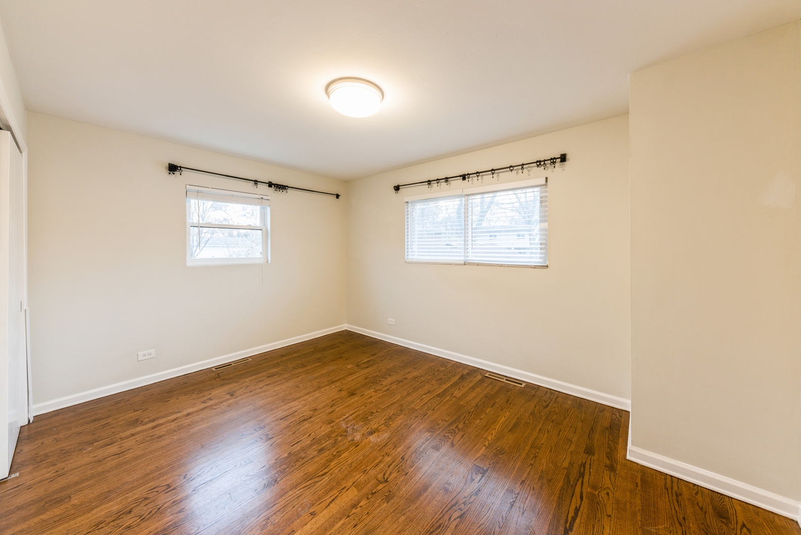 219 North Butterfield Road Libertyville, IL 60048 - Photo 8 of 14 an empty room with wooden floor and windows