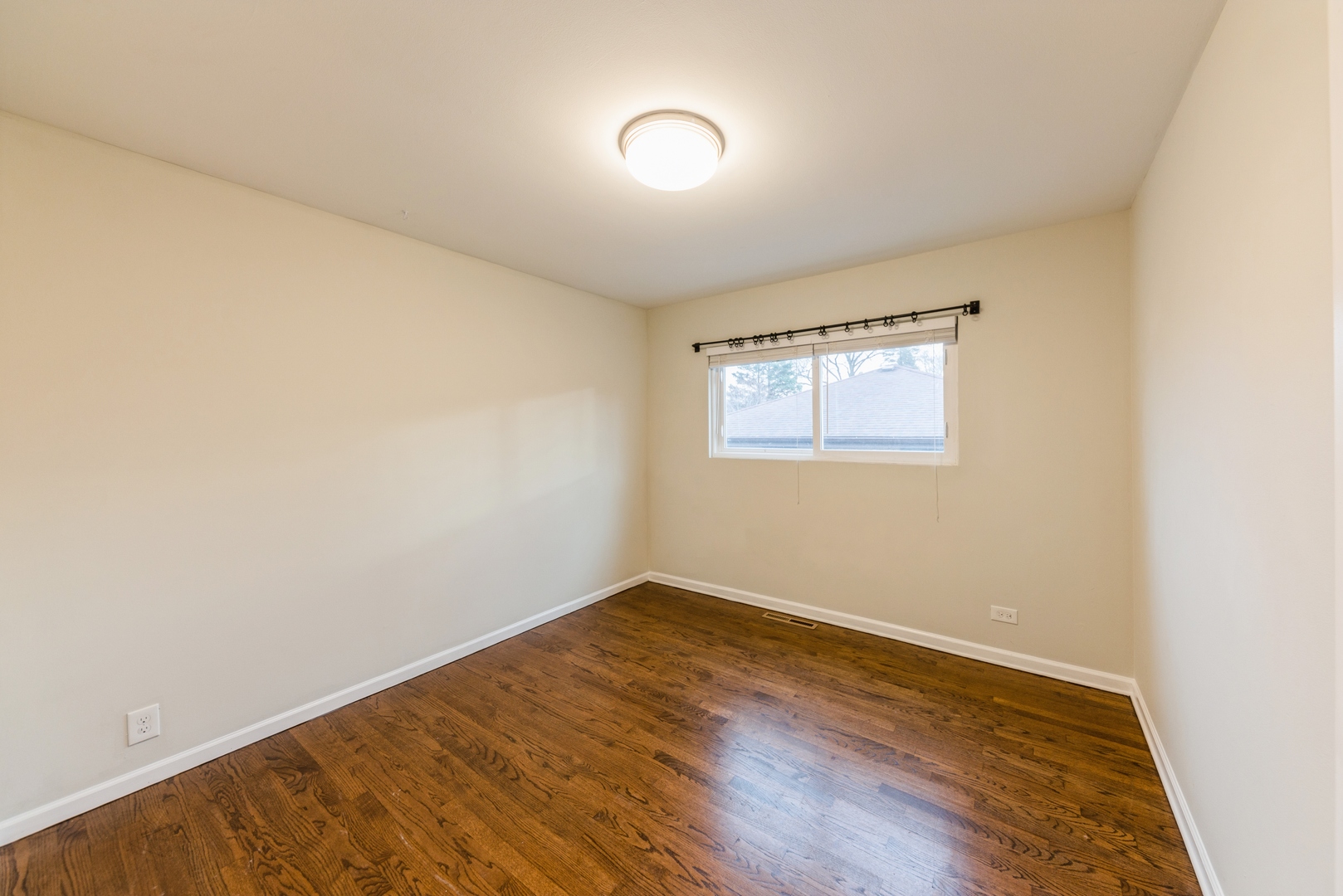 219 North Butterfield Road Libertyville, IL 60048 - Photo 9 of 14 an empty room with wooden floor and windows