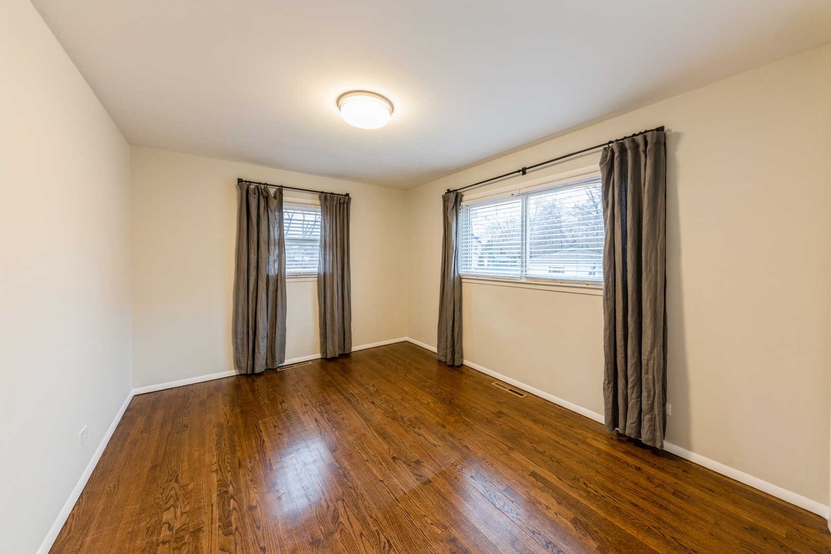 219 North Butterfield Road Libertyville, IL 60048 - Photo 10 of 14 an empty room with wooden floor and windows