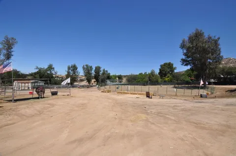 a view of swimming pool with outdoor seating and yard in back