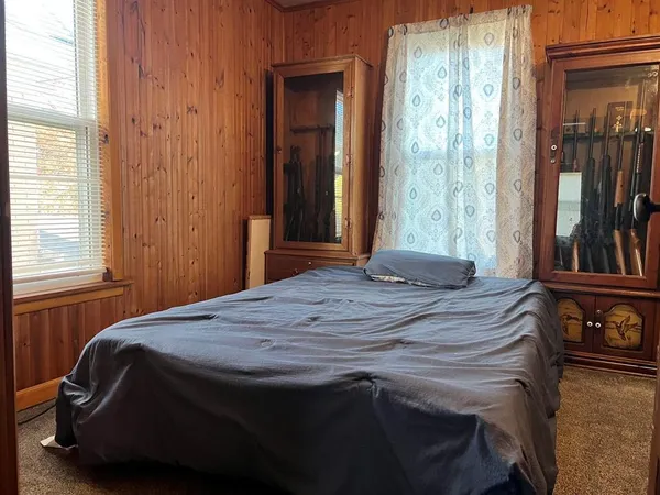 a bedroom with a bed and a window