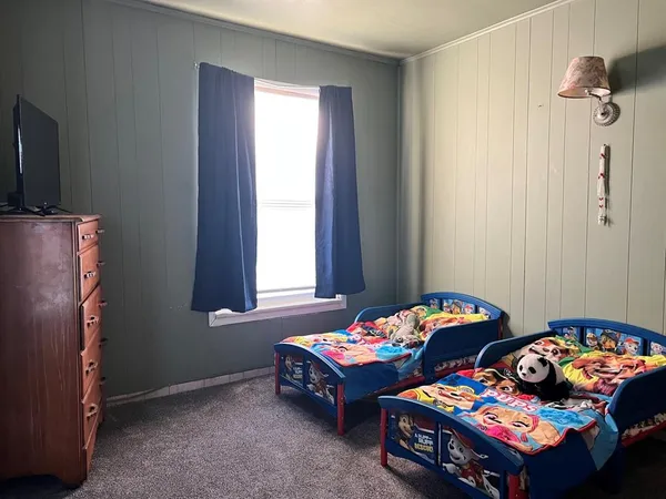 a bedroom with bed and a window