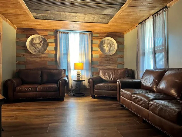 a living room with couch and a clock