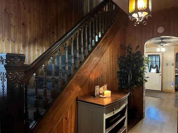 a view of entryway and hall with wooden floor