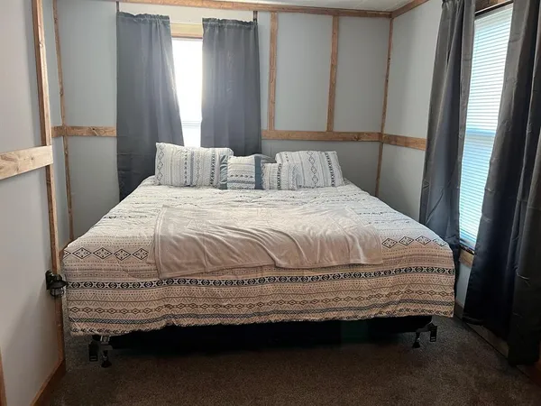 a bedroom with a bed and window