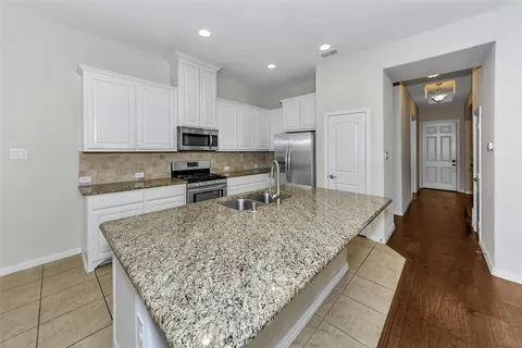 a kitchen with a stove a sink and a refrigerator