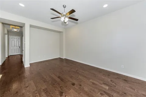 an empty room with wooden floor and door