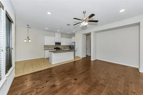 a view of kitchen with refrigerator and microwave