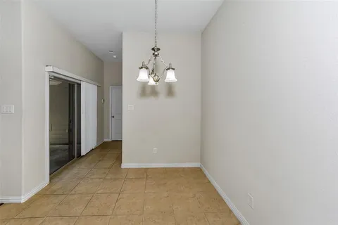 a view of a room with wooden floor and chandelier