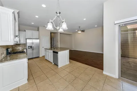 a kitchen with stainless steel appliances a refrigerator and a stove top oven