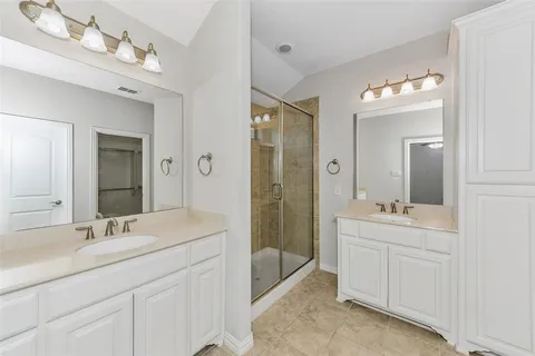 a spacious bathroom with a double vanity sink mirror and double