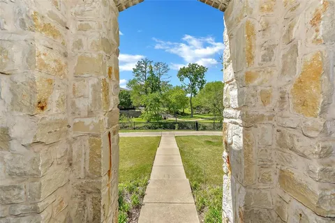 a view of a pathway both side of a brick house