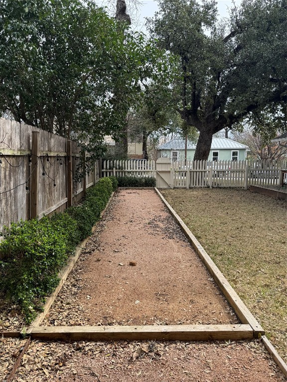 1308 Navasota Street Austin, TX 78702 - Photo 3 of 14 a view of a wooden fence and a tree