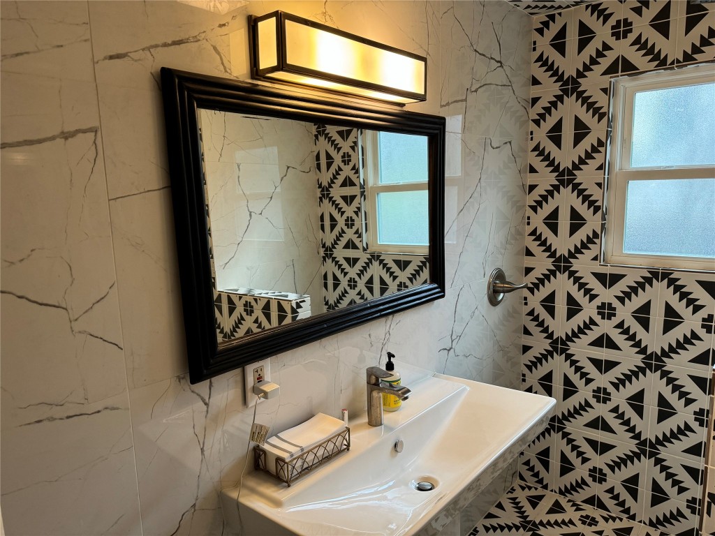 1308 Navasota Street Austin, TX 78702 - Photo 8 of 14 a bathroom with a sink and a mirror