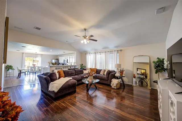 a living room with furniture and wooden floor