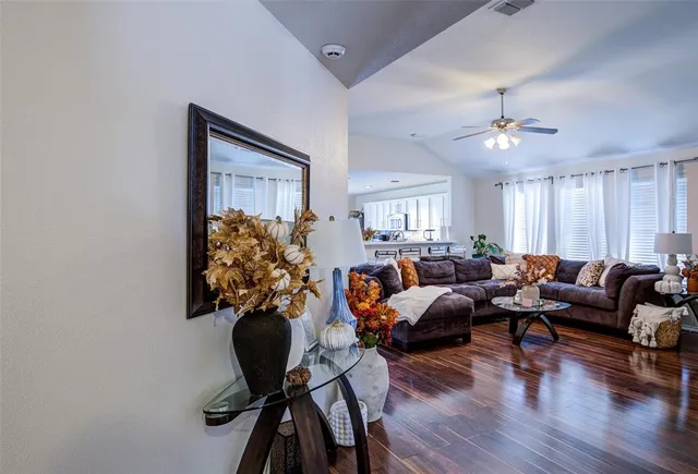 a living room with furniture potted plant and a chandelier