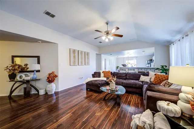 a living room with furniture and wooden floor