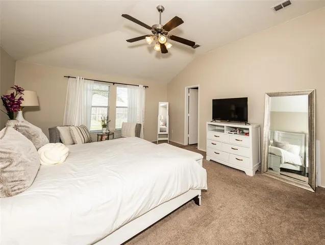 a bedroom with bed tv and a fireplace