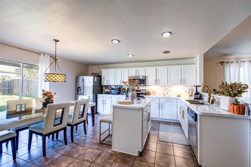 8817 King Ranch Drive Cross Roads, TX 76227 - Photo 9 of 24 a kitchen with a sink a counter top space and appliances