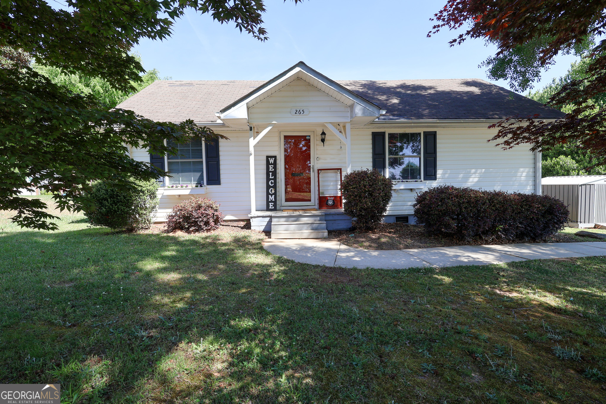 265 Club Drive Locust Grove, GA 30248 - Photo 1 of 20 a front view of a house with a garden and fire pit