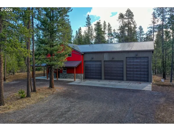 a view of a house with a yard and tree