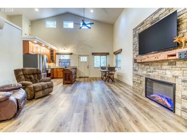 a living room with furniture a flat screen tv and a fireplace