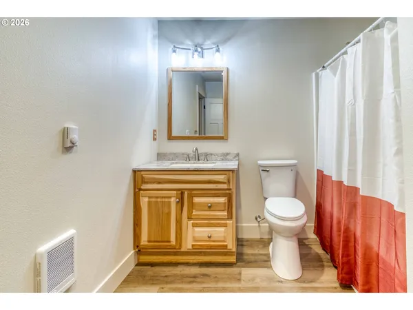 a bathroom with a toilet a sink a vanity and mirror