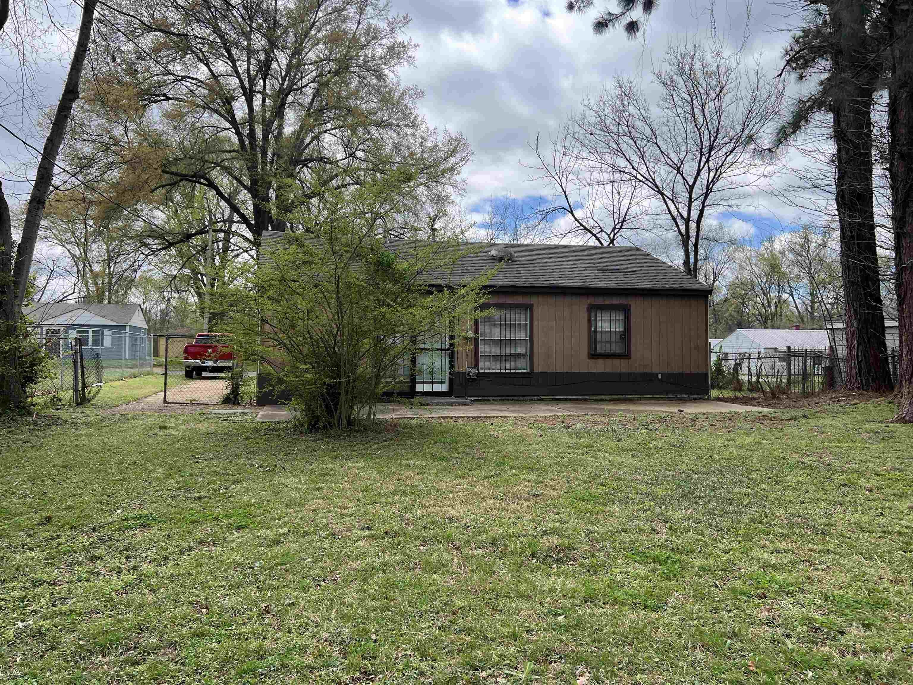 892 Restbrook Avenue Memphis, TN 38127 - Photo 11 of 11 Back of property with a patio area and roof with shingles