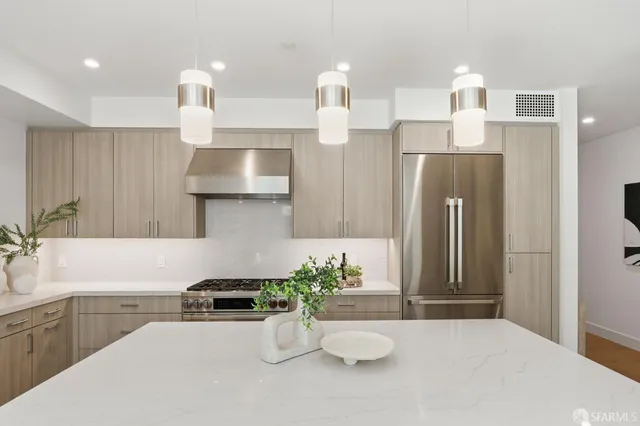 a spacious bedroom with a bed and a lamp