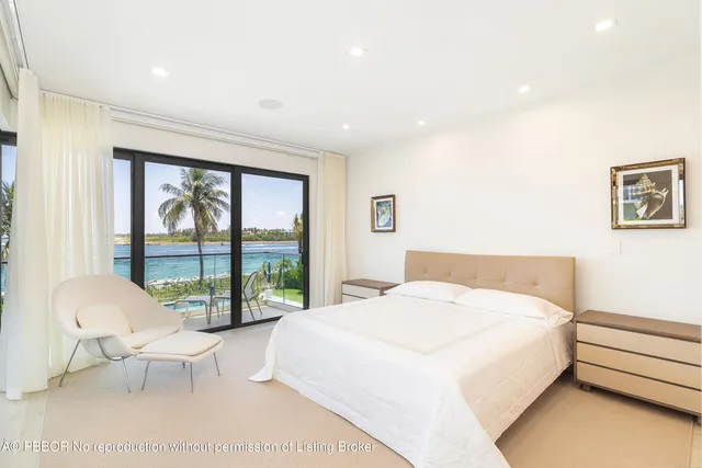 a spacious bedroom with a large bed and a large window