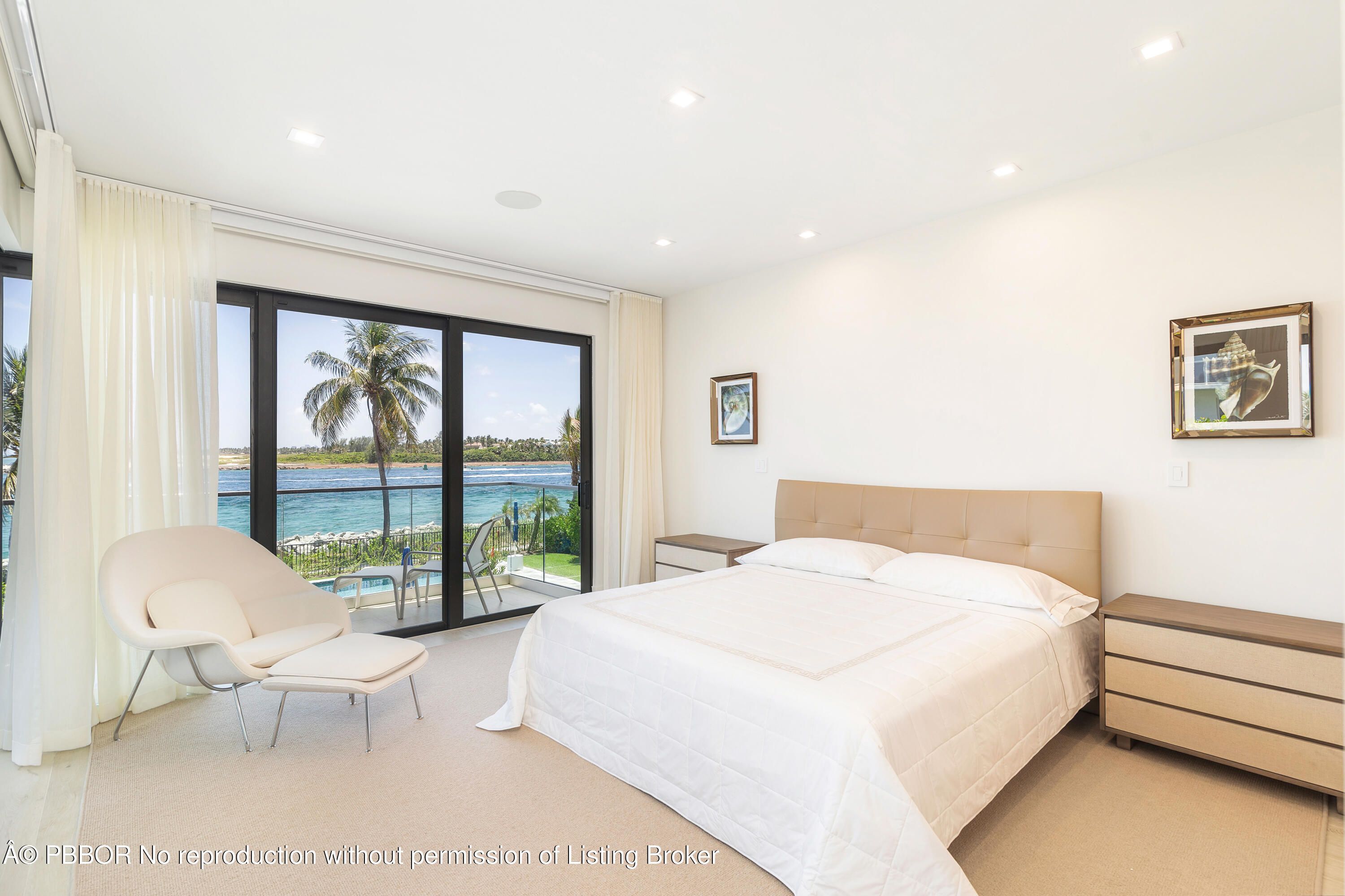 150 Inlet Way, Unit 1E Palm Beach Shores, FL 33404 - Photo 15 of 41 a spacious bedroom with a large bed and a large window