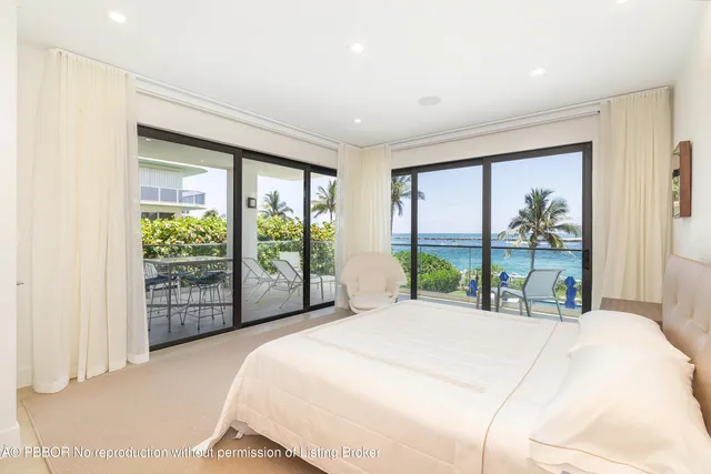 a bedroom with a large bed and a large window