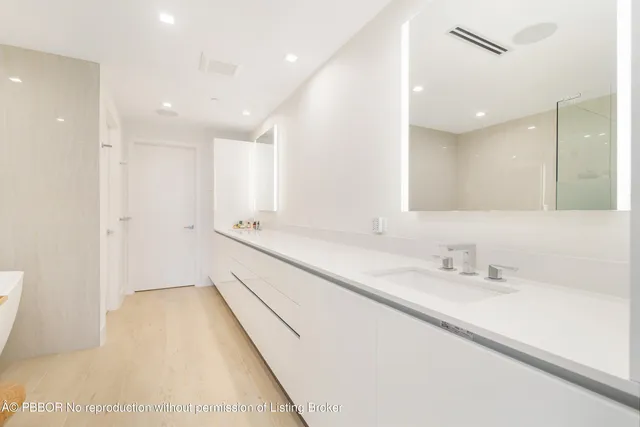 a bathroom with a double vanity sink and a mirror