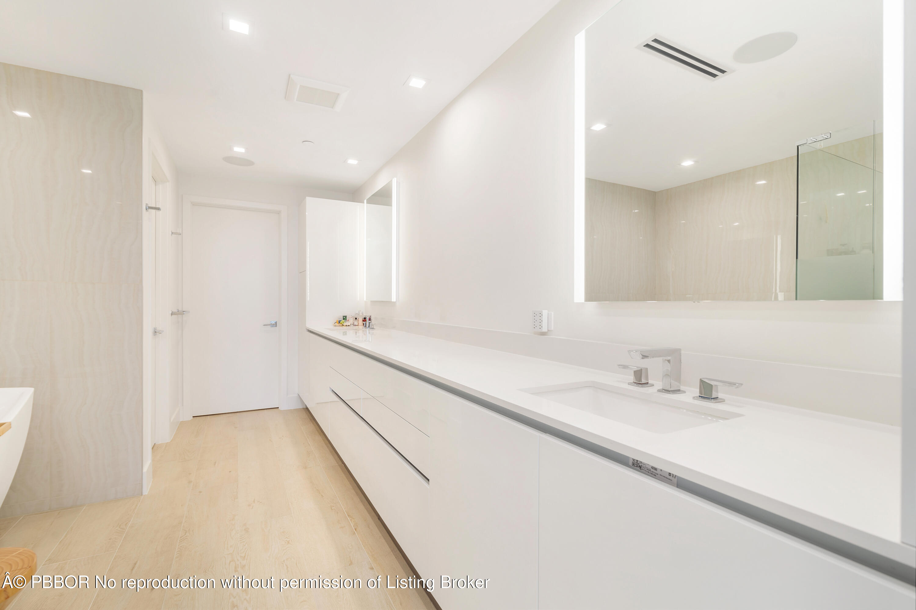 150 Inlet Way, Unit 1E Palm Beach Shores, FL 33404 - Photo 17 of 41 a bathroom with a double vanity sink and a mirror