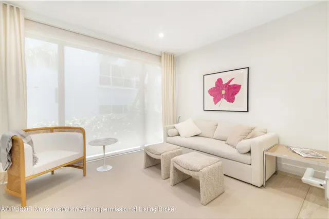 a living room with furniture a rug and a white door