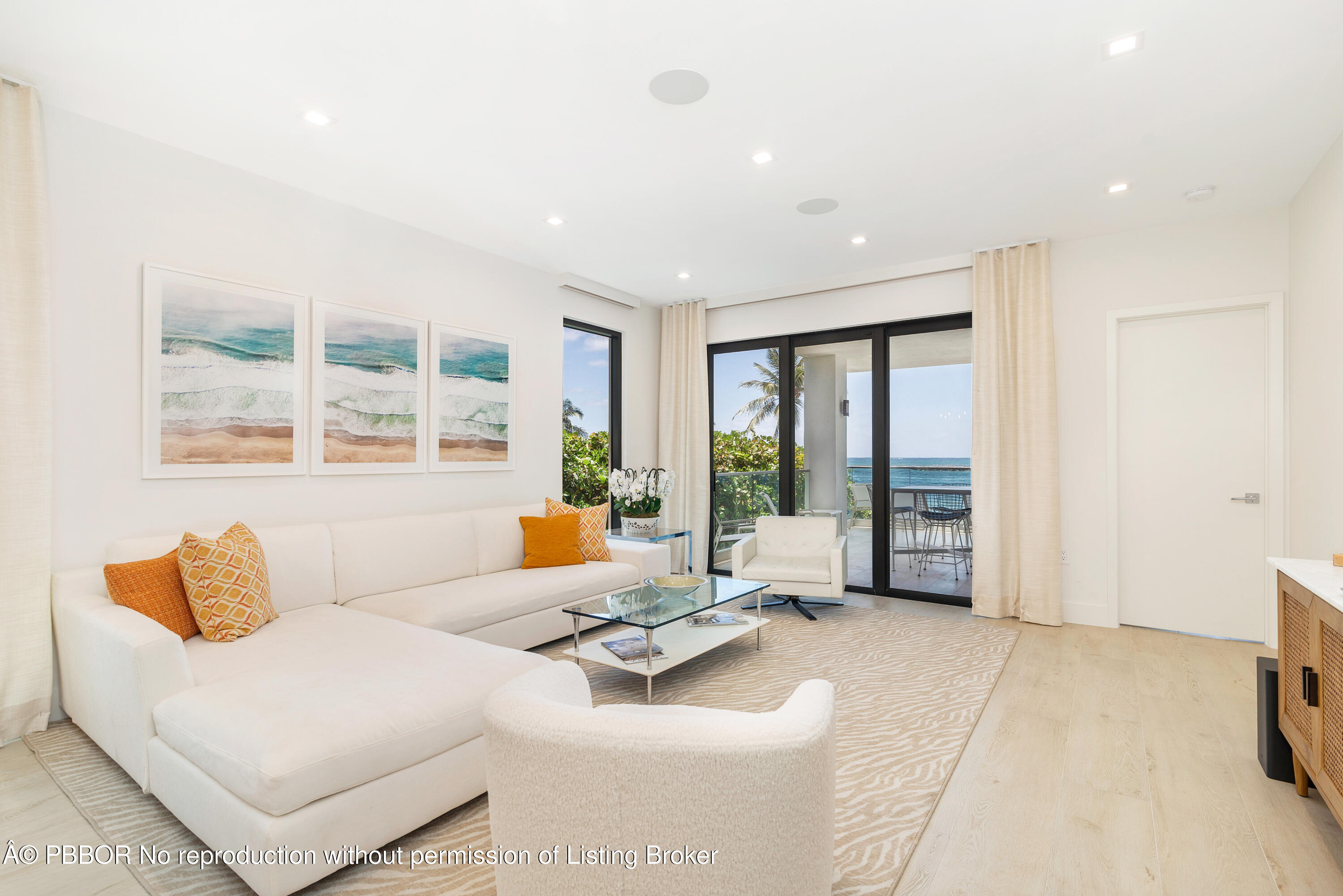 150 Inlet Way, Unit 1E Palm Beach Shores, FL 33404 - Photo 2 of 41 a living room with furniture and large windows