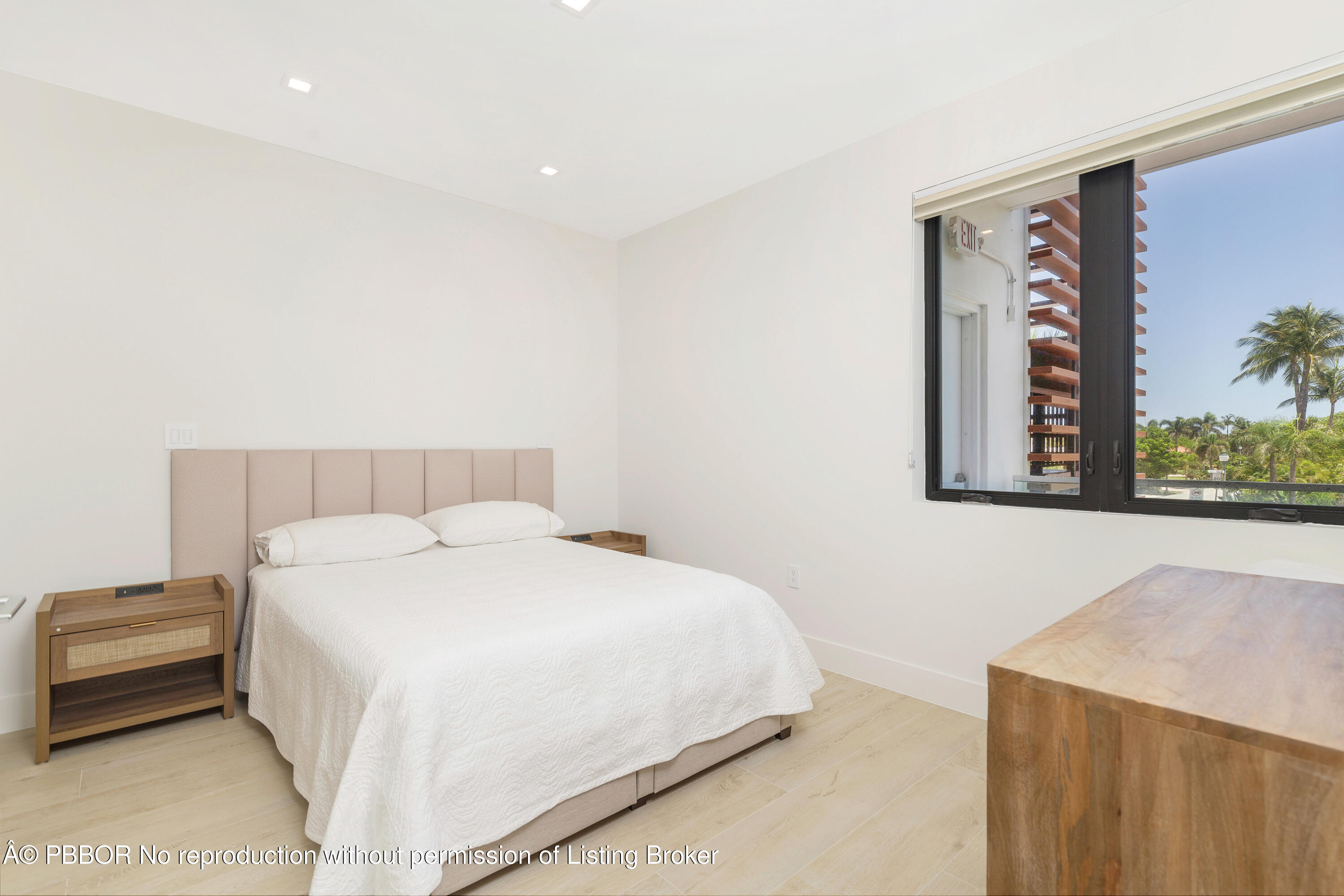 150 Inlet Way, Unit 1E Palm Beach Shores, FL 33404 - Photo 21 of 41 a bedroom with a bed and a painting on the wall