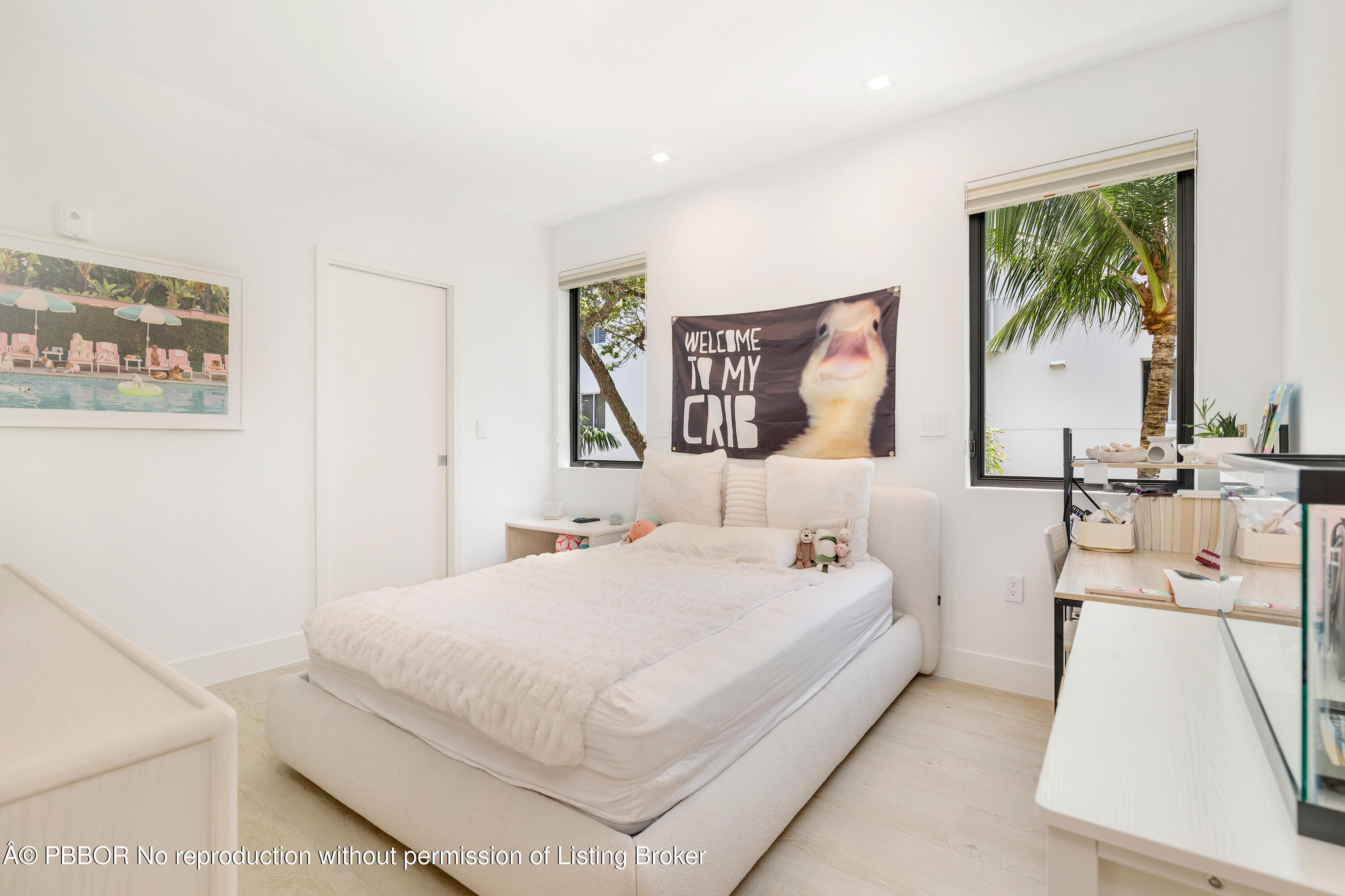 150 Inlet Way, Unit 1E Palm Beach Shores, FL 33404 - Photo 23 of 41 a bedroom with a bed and a painting on the wall