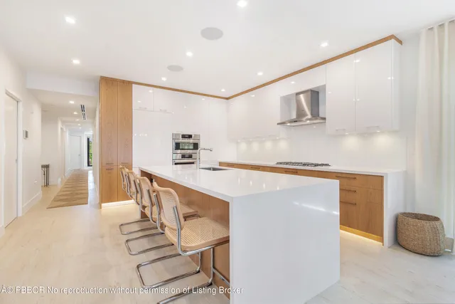 a kitchen with stainless steel appliances kitchen island granite countertop a sink and cabinets