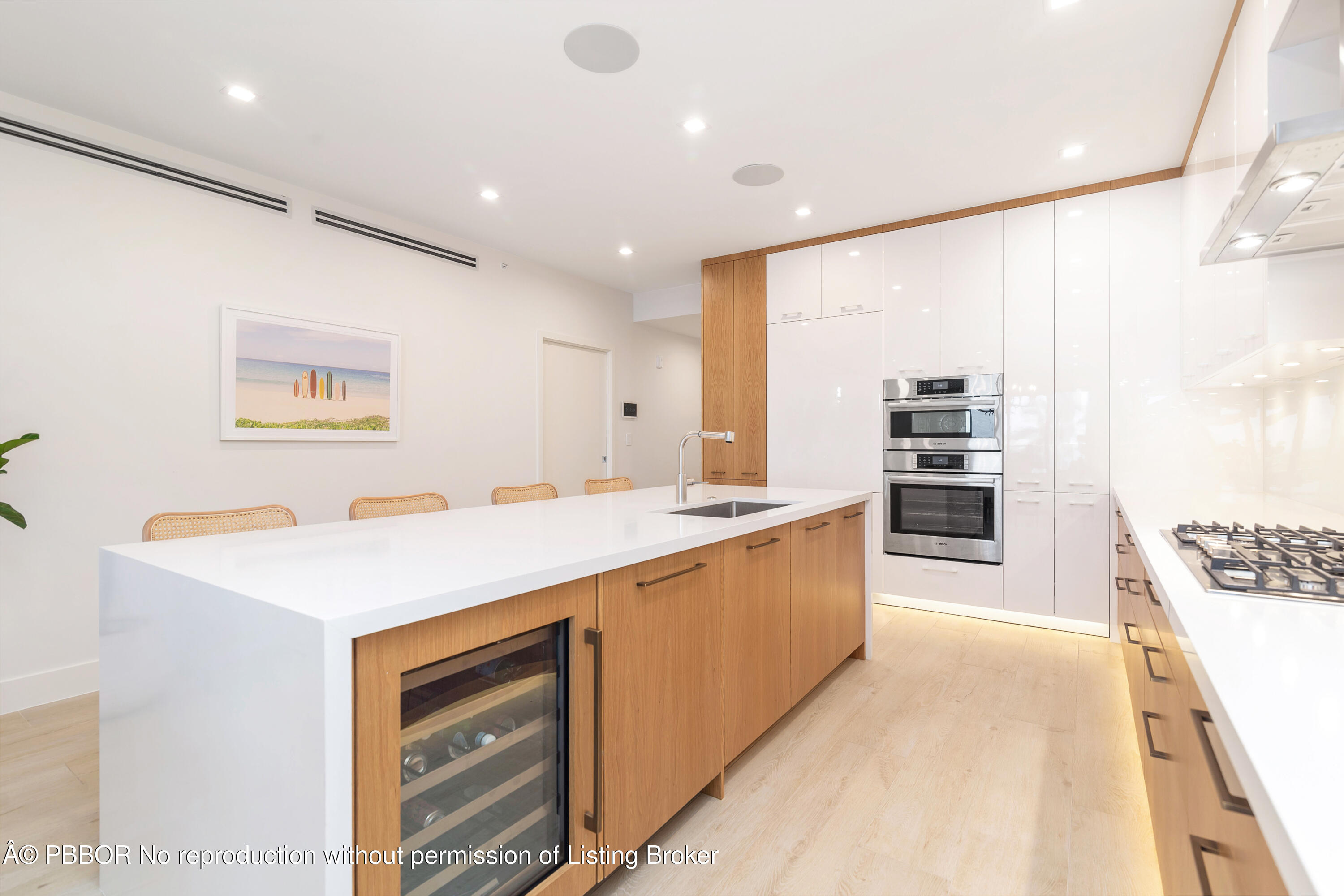 150 Inlet Way, Unit 1E Palm Beach Shores, FL 33404 - Photo 10 of 41 a large kitchen with stainless steel appliances a large counter top a stove and a refrigerator