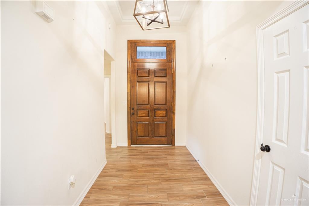 8725 Spoonbill Street Harlingen, TX 78552 - Photo 16 of 18 a view of a hallway with wooden floor