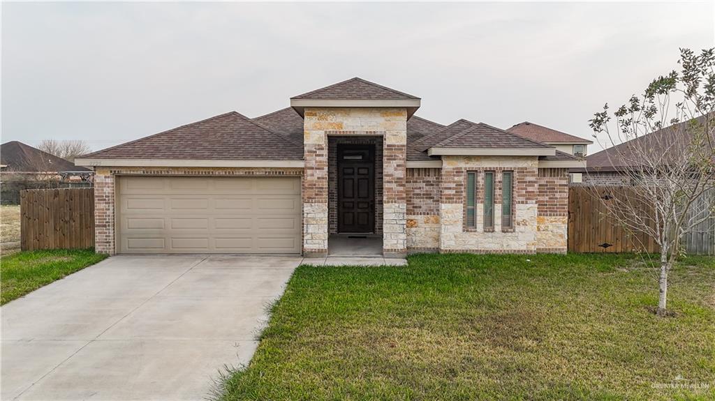 8725 Spoonbill Street Harlingen, TX 78552 - Photo 2 of 18 front view of a house with a yard