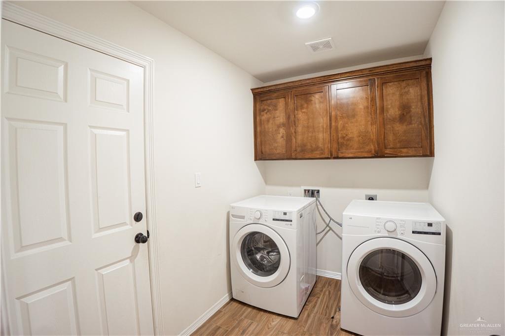 8725 Spoonbill Street Harlingen, TX 78552 - Photo 3 of 18 a view of a storage and utility room with washer and dryer