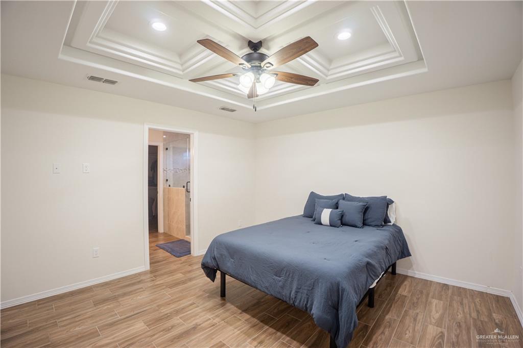 8725 Spoonbill Street Harlingen, TX 78552 - Photo 4 of 18 a bedroom with a bed and a ceiling fan